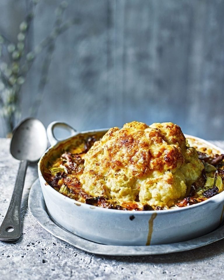 Whole baked cauliflower with pearl barley, wild mushrooms and cheese